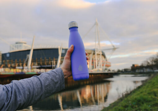A reusable water bottle pictured in front of the River Taff and Principality Stadium in Cardiff