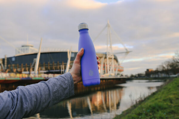 A reusable water bottle pictured in front of the River Taff and Principality Stadium in Cardiff
